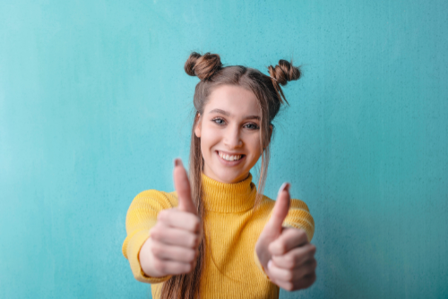 thumbs up at the camera